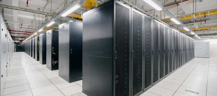 Aisle of illuminated server racks inside a modern data center