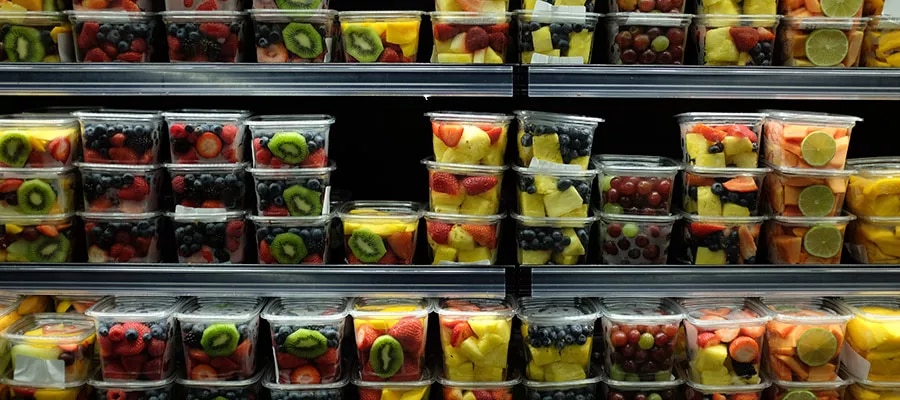 Fresh-cut fruit in containers kept cold on refrigerated supermarket shelves